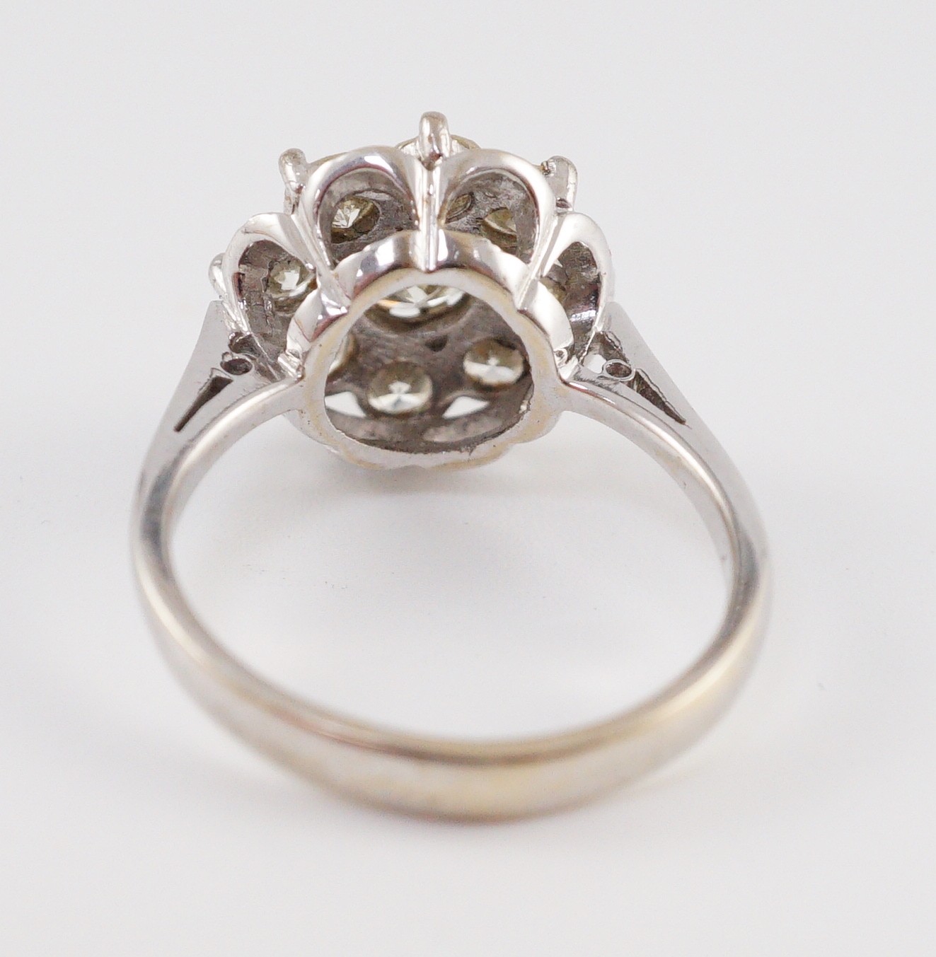A modern 18ct white gold and nine stone diamond illusion set circular cluster ring